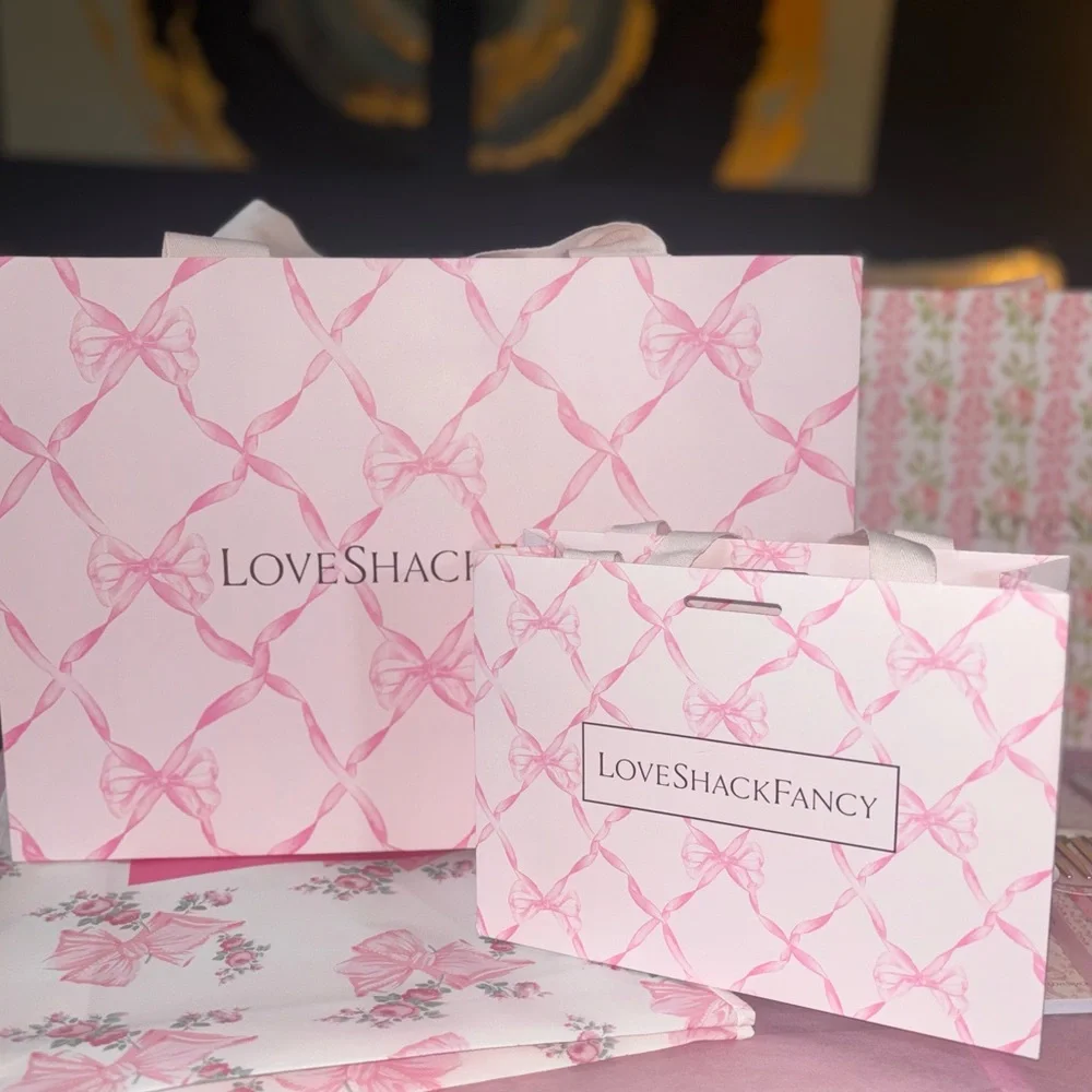 LoveShackFancy pink shopping gift bags with pink ribbon bow pattern